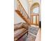 Grand foyer with staircase, high ceilings, large arched window, and decorative rug at 2320 Whispering Way, Indianapolis, IN 46239