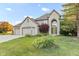 Charming two-story home with a well-manicured lawn, three-car garage and inviting curb appeal at 2320 Whispering Way, Indianapolis, IN 46239