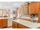 Open kitchen layout with white countertops, tile backsplash, hardwood cabinets, and stainless steel dishwasher at 2320 Whispering Way, Indianapolis, IN 46239