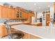 Kitchen with white countertops, tile backsplash, hardwood cabinets, island seating, and decor at 2320 Whispering Way, Indianapolis, IN 46239