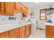 Convenient laundry room with oak cabinets, sink, and modern washer/dryer at 2320 Whispering Way, Indianapolis, IN 46239