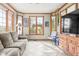Comfortable living area with large windows offering natural light, tiled flooring, and plush seating at 2320 Whispering Way, Indianapolis, IN 46239