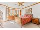 Sunlit main bedroom featuring a spacious bay window and elegant wooden furniture at 2320 Whispering Way, Indianapolis, IN 46239