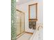 Bathroom showing a glass shower, patterned wallpaper and a single window at 2320 Whispering Way, Indianapolis, IN 46239