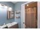 Bathroom with modern vanity and shower featuring decorative shower curtain at 31 Morningside Ct, Whiteland, IN 46184