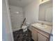 Bathroom with a shower and vanity with modern cabinets and tile flooring at 3142 Lennon Ln, Indianapolis, IN 46235