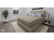 Serene bedroom showcasing a comfortable bed, neutral decor, and a lush potted plant at 3142 Lennon Ln, Indianapolis, IN 46235