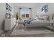 Sunlit bedroom with a neutral color palette, complemented by a comfortable bed and stylish furnishings at 3142 Lennon Ln, Indianapolis, IN 46235