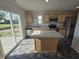 Well-lit kitchen featuring an island, stainless steel appliances, and sliding glass doors to the backyard at 3142 Lennon Ln, Indianapolis, IN 46235