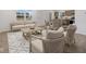 Sun-drenched living room featuring stylish furnishings, hardwood floors, and an adjacent dining area at 3142 Lennon Ln, Indianapolis, IN 46235