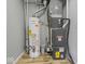 Basement utility area featuring a water heater and furnace at 320 Sunset Dr, Shelbyville, IN 46176