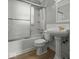 Traditional bathroom featuring a tub with shower, vanity sink, and tile flooring at 320 Sunset Dr, Shelbyville, IN 46176