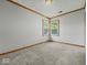 Cozy bedroom with fresh carpeting and natural light from a pair of windows at 320 Sunset Dr, Shelbyville, IN 46176