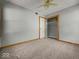 Cozy bedroom with neutral tones, carpet flooring, closet and natural wood trim at 320 Sunset Dr, Shelbyville, IN 46176