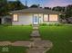 Charming single-story home with a well-maintained lawn and inviting front entrance at 320 Sunset Dr, Shelbyville, IN 46176
