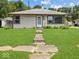 Charming single-story home with a well-maintained lawn and inviting front entrance at 320 Sunset Dr, Shelbyville, IN 46176