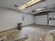 Unfinished garage with concrete floor and roll up door at 320 Sunset Dr, Shelbyville, IN 46176