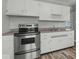 Kitchen with stainless steel oven, updated cabinets, and a double basin sink at 320 Sunset Dr, Shelbyville, IN 46176