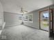 Open living room featuring large windows and neutral carpeting at 320 Sunset Dr, Shelbyville, IN 46176