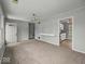 Neutral living room offering seamless access to the kitchen and other areas at 320 Sunset Dr, Shelbyville, IN 46176