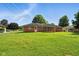 Well maintained, grassy backyard with a brick house and full fence at 3504 White River Ct, Anderson, IN 46012