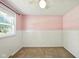 Bedroom with pink and white walls, carpet, ceiling fan, and window at 3504 White River Ct, Anderson, IN 46012