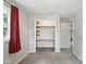 Bedroom featuring a closet with wooden shelves and neutral walls and carpets at 3504 White River Ct, Anderson, IN 46012