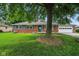Charming brick ranch-style home with blue shutters, two-car garage, and mature trees at 3504 White River Ct, Anderson, IN 46012