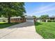 Ranch-style home with two-car garage, brick facade, and large front yard with driveway at 3504 White River Ct, Anderson, IN 46012