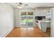 Eat-in kitchen with white cabinets, breakfast bar, and sliding glass door to outdoor deck at 3504 White River Ct, Anderson, IN 46012