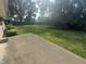 View of a spacious backyard with mature trees and lush grass from the patio at 4032 Roselawn Ave, Columbus, IN 47203