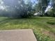 Expansive backyard featuring mature trees and a lush lawn at 4032 Roselawn Ave, Columbus, IN 47203