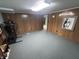 Spacious basement featuring wood paneling, neutral carpet, and room for exercise equipment at 4032 Roselawn Ave, Columbus, IN 47203