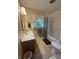 Bright bathroom with vanity, sink, and bathtub with shower at 4032 Roselawn Ave, Columbus, IN 47203