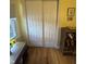 Bright bedroom closet offers paneled doors and a wood floor at 4032 Roselawn Ave, Columbus, IN 47203