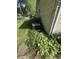View of the exterior featuring an air conditioning unit surrounded by lush greenery at 4032 Roselawn Ave, Columbus, IN 47203