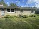 Exterior of the house with a well-maintained lawn and landscaping at 4032 Roselawn Ave, Columbus, IN 47203