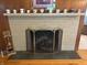 The Gathering room fireplace has a stone facade and a decorative display shelf above it at 4032 Roselawn Ave, Columbus, IN 47203