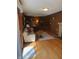 Cozy Gathering room featuring wood paneling, a sliding glass door, and a brick fireplace at 4032 Roselawn Ave, Columbus, IN 47203
