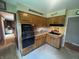 Cozy kitchen featuring wood cabinets, black appliances, and access to another room at 4032 Roselawn Ave, Columbus, IN 47203