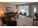 Bright and airy living room featuring neutral walls, large windows, and comfortable seating at 4032 Roselawn Ave, Columbus, IN 47203