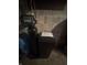 Close-up of a water softener unit and other equipment in the utility area at 4032 Roselawn Ave, Columbus, IN 47203