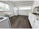 Modern kitchen with hardwood-style flooring, white appliances, and ample counter space at 411 N 18Th St, Noblesville, IN 46060