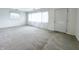 Spacious, carpeted living room with bright natural light, and a convenient entry door at 411 N 18Th St, Noblesville, IN 46060