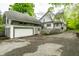 Exterior view of home with a detached garage and well-maintained driveway at 4130 N Meridian St, Indianapolis, IN 46208