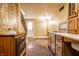Open kitchen featuring brick accents, stainless appliances, a white door, and unique decorative walls at 4130 N Meridian St, Indianapolis, IN 46208