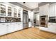 Spacious kitchen with stainless steel refrigerator, white cabinets, double oven, and view to the doorway at 4130 N Meridian St, Indianapolis, IN 46208