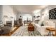 Elegant living room with hardwood floors, a decorative rug, stylish furniture, and abundant natural light at 4130 N Meridian St, Indianapolis, IN 46208