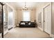 Sitting room with a leather couch, chandelier, and French doors leading to an en-suite bathroom at 4130 N Meridian St, Indianapolis, IN 46208