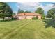 Expansive backyard featuring a well-maintained lawn, patio, and charming brick exterior at 425 Saddle Hill Ct, Indianapolis, IN 46234